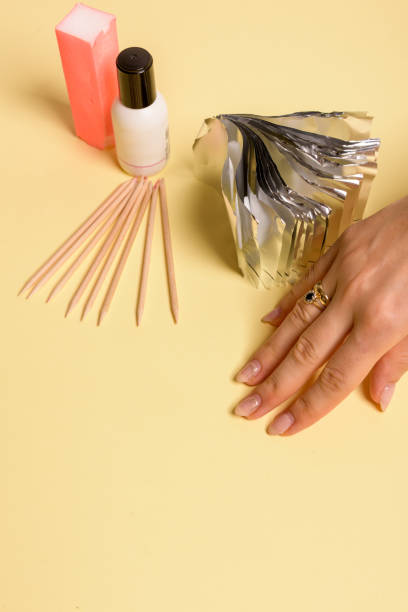 istock Hybrid manicure removal kit. The procedure for removing varnish from nails in progress. 1190588557