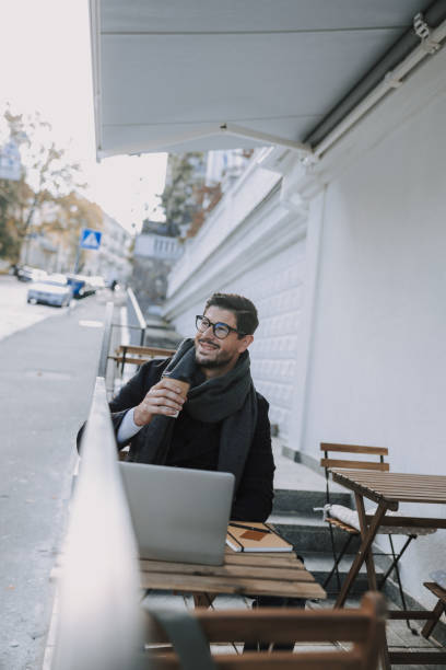 istock Caucasian man in eyeglasses drinking beverage at table 1190589084
