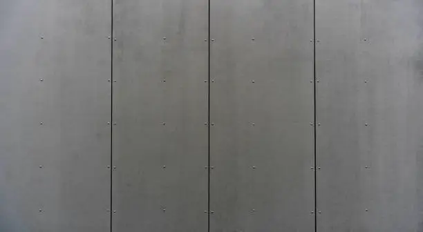 Photo of modern materials in the construction industry. Texture of metal cladding of a building facade closeup.