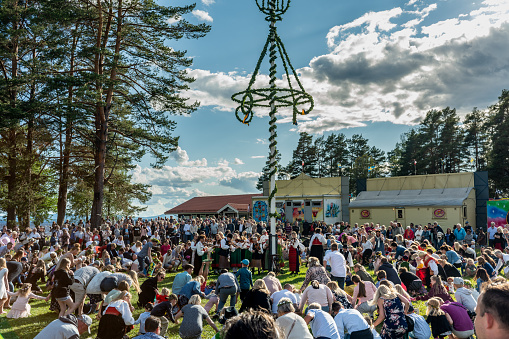 Orsa, Sweden, 21-06-2019. Lot of people dancing in a ring around the midsummer pole, in the traditional celebration of midsummer in Sweden