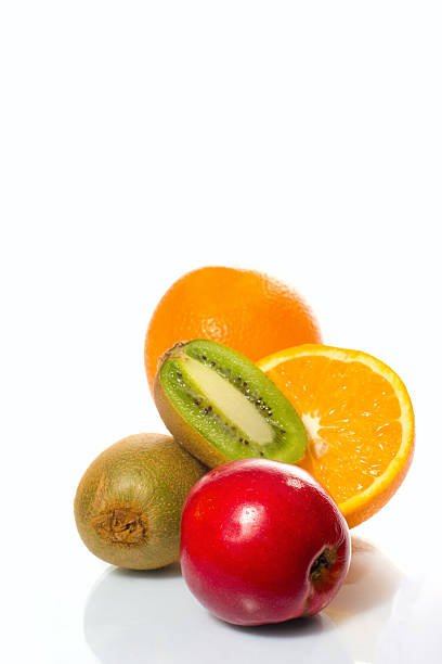 Front view of a composition made of various layers of sliced fruits such as apples, lime, lemon, grapefruit, kiwi and orange. The layers are detached so is visible the inside of each fruit.