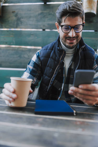 istock Smiling Caucasian man is drinking tea outside 1190591589