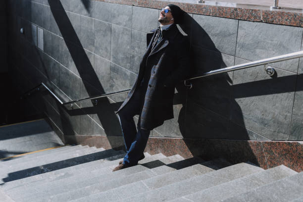 istock Calm man leaning on the wall on stairs outside 1190591673