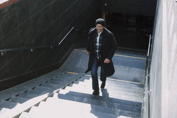 istock Caucasian guy with his bag walking in city 1190591696