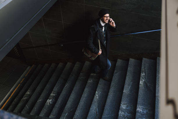 istock Caucasian attractive guy in glasses walking in underground on stairs 1190591709
