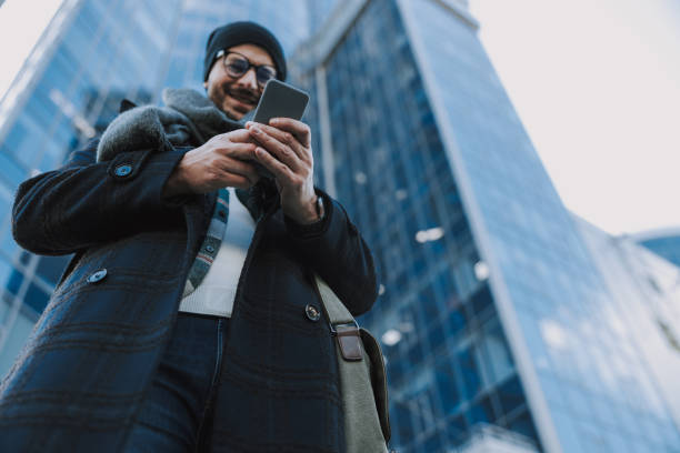 istock Happy man is using his smartphone in town 1190592184