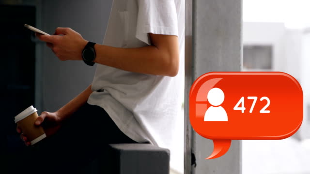 Teenager sitting on a veranda rail texting 4k