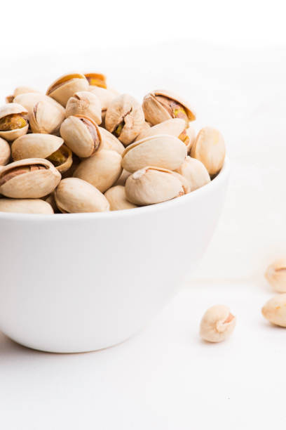 istock Bowl of roasted pistachios on a white background 1190593576
