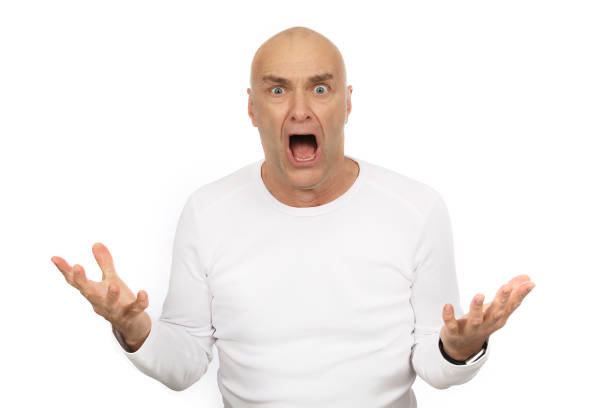 Man with bald head and white shirt is excited in the studio