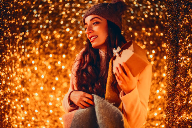 istock Smiling woman holding  gift box 1190597176