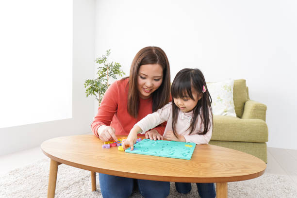 istock Child and parent studying at home 1190599959