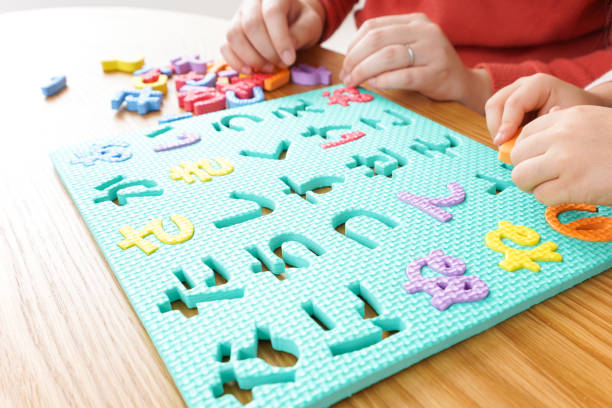 istock Child and parent studying at home 1190600526