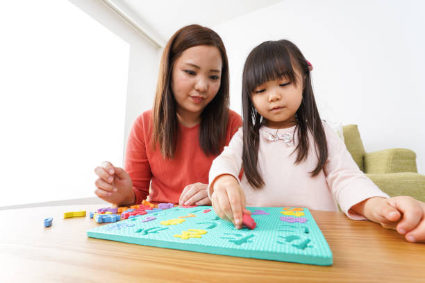 istock Child and parent studying at home 1190600532