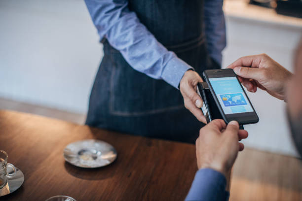 istock Man paying with mobile phone credit card app 1190600771