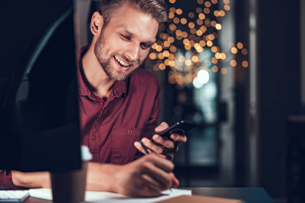 istock Happy young man working in the evening at his office 1190602006