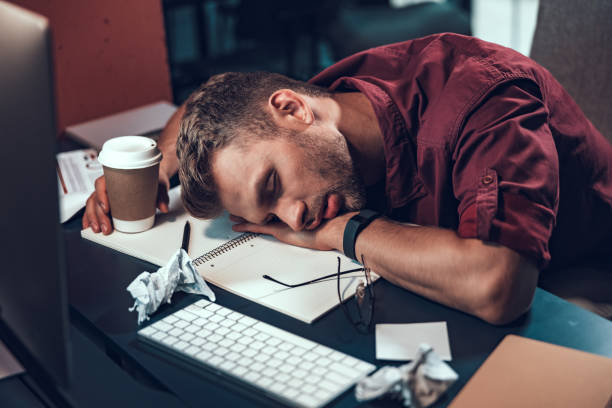 istock Young man is sleeping at the desk 1190602050