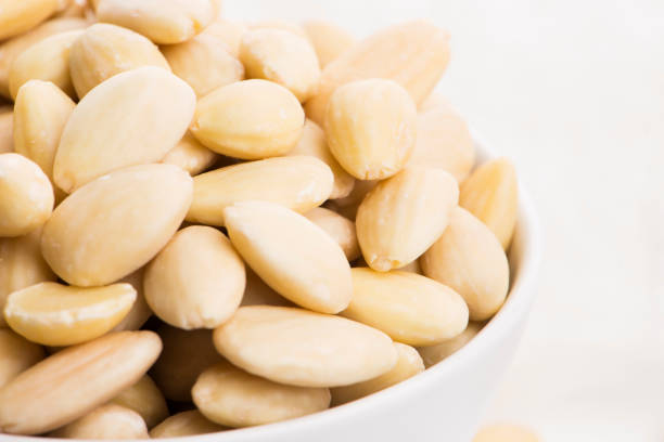 istock Bowl of almonds on a white background 1190602095