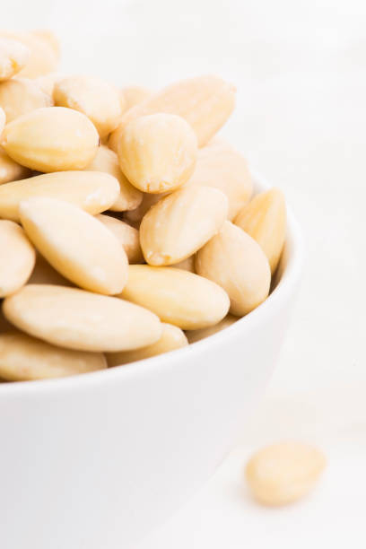 Bowl of almonds on a white background