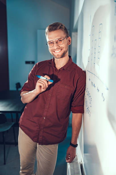 istock Smiling young guy leaning against a wall 1190602194