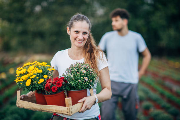 istock Woman working outdoors on flower farm 1190602297