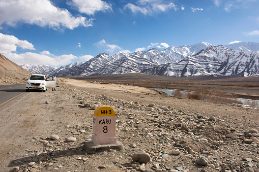 JAMMU KASHMIR, INDIA - MARCH 20 : Retro Milestone on the road information distance on Leh Manali and Srinagar Leh Highway at Leh Ladakh on March 20, 2019 in Jammu and Kashmir, India