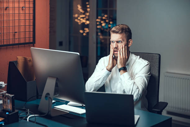 istock Young man is looking anxiously at the computer 1190605395