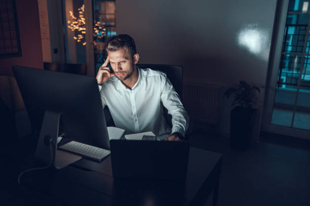 istock Young man thinking near the computer in the office 1190605415