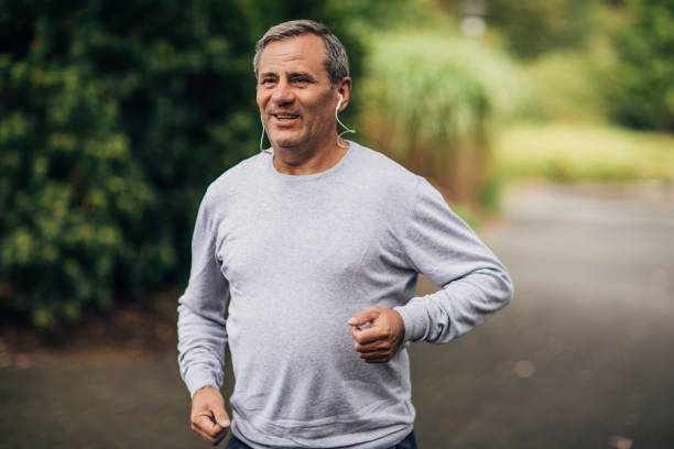 istock Charming senior man jogging in park 1190606873