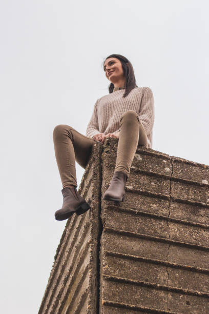 istock Girl on wall 1190607509