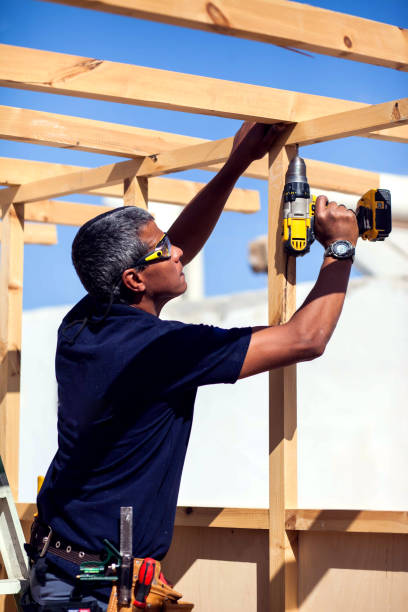 istock Handyman with toolsbelt and yellow drill in his hands 1190609701