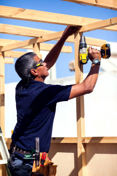 istock Handyman with toolsbelt and yellow drill in his hands 1190609705
