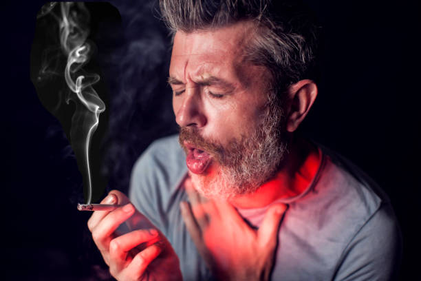 istock Man smokes cigarette and has problem with lungs. Cigarette addiction concept 1190610240