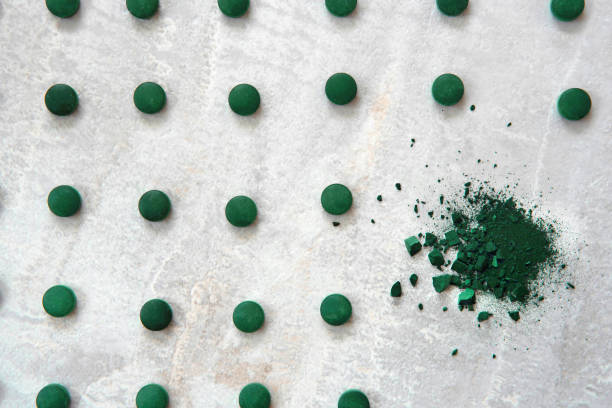 istock Spirulina algae powder and tablets on gray background from top view 1190616491