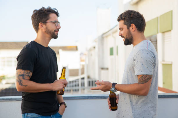 istock Old male friends drinking beer and talking 1190617908