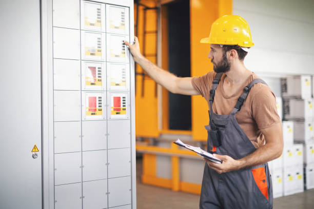 istock Worker in the factory operating machines 1190620840