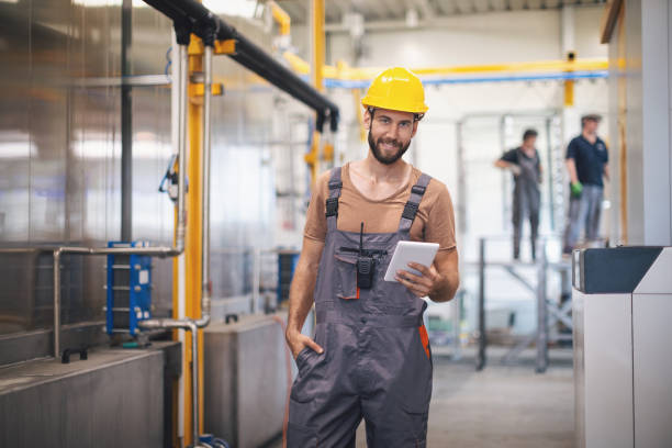 istock Worker in the factory operating machines 1190621388