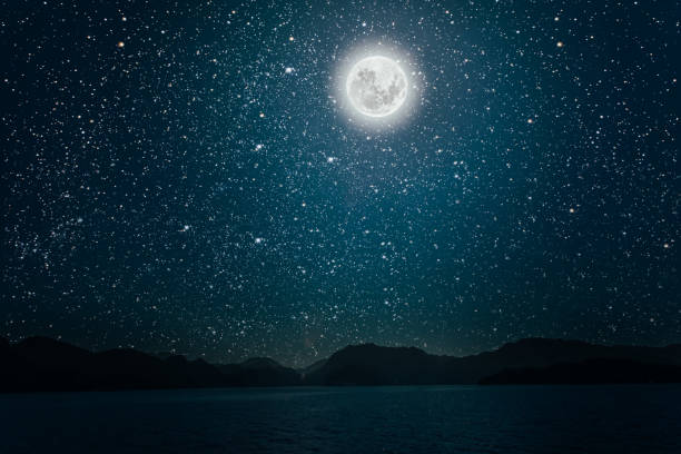 istock moon against a bright night starry sky reflected in the sea 1190622709