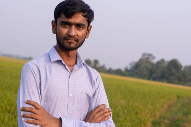 istock Young farmer showing thums up in paddy field. Successful Agriculture concept 1190623021