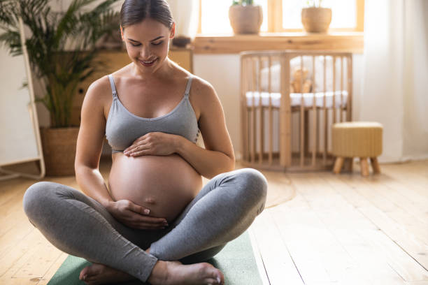 istock Smiling pregnant lady is sitting on floor 1190626339