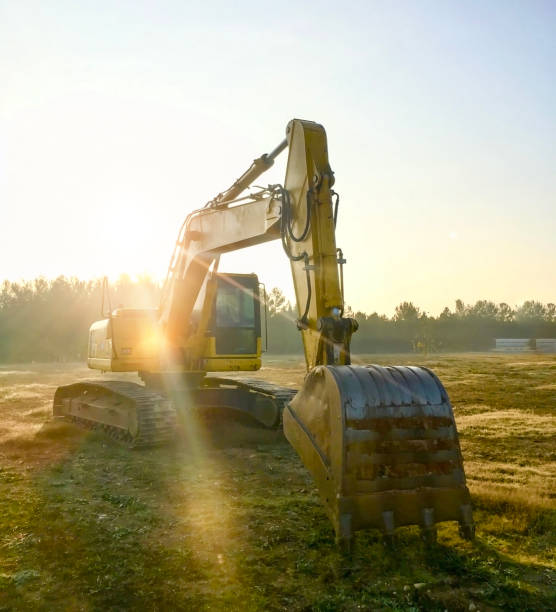 Yellow excavator at construction site into mud stock photo