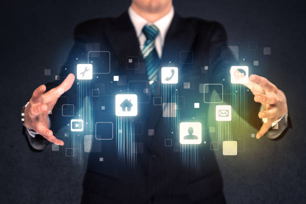 istock Businessman holding blue applications 1190628382