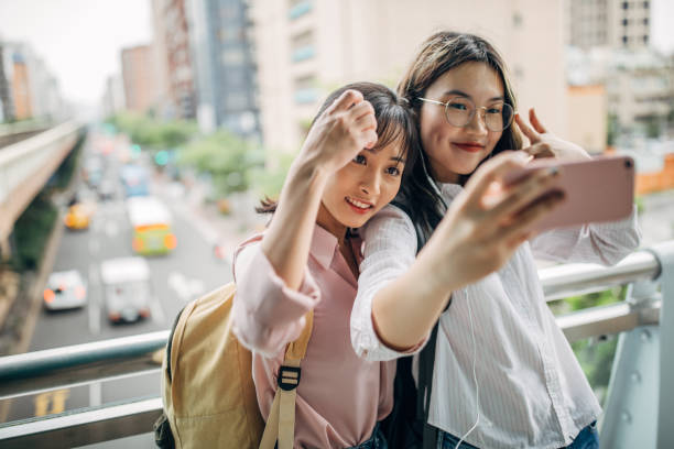 istock Two young women taking a selfie in city 1190629238