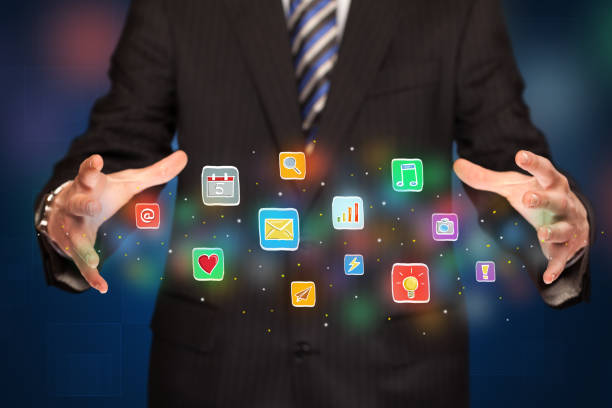 istock Businessman holding application icons 1190629403