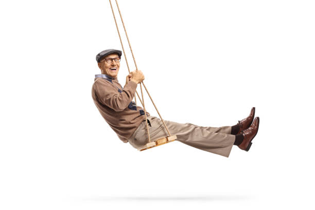 istock Smiling senior getleman swinging and looking at the camera 1190629672