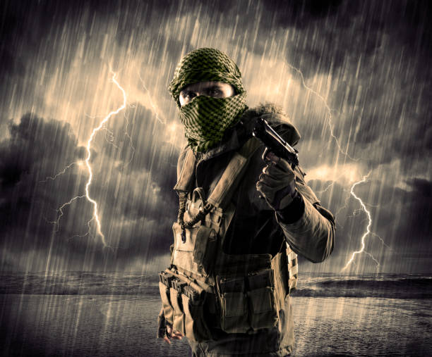 istock Dangerous armed terrorist with mask and gun in a thunderstorm with lightning 1190631076