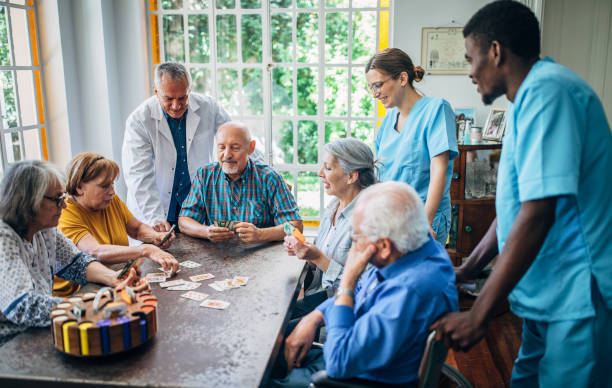 istock Senior people playing cards in nursing home and enjoying time 1190632183