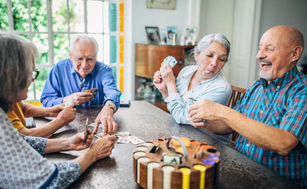 istock Old friends playing cards in nursing home 1190632432
