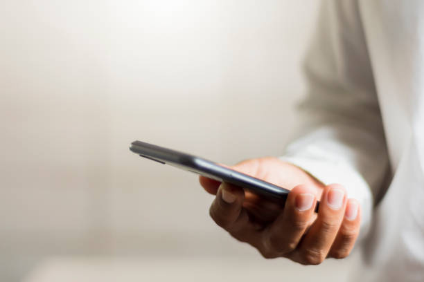 istock Business people use their smartphones to work through a database that is protected with intelligent systems. 1190633350