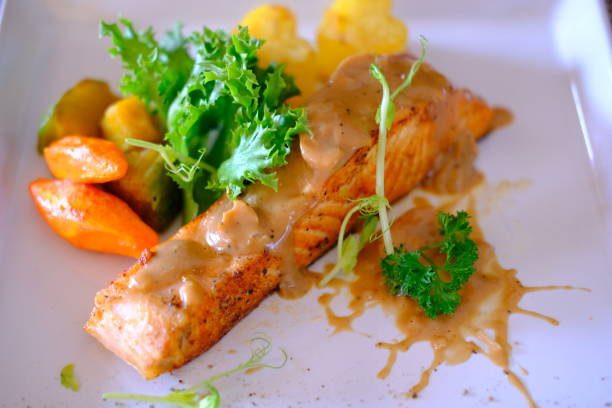 istock Grilled salmon steak with white sauce 1190633405