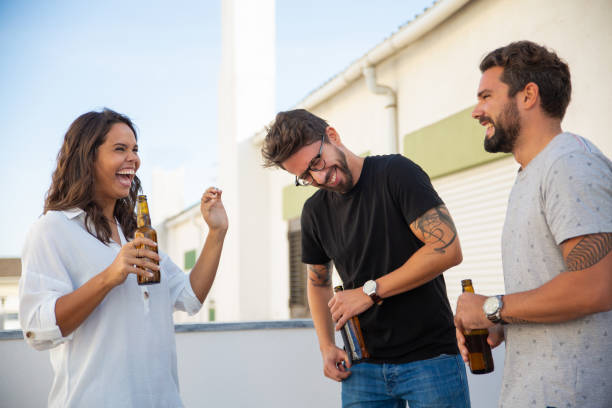 istock Excited happy friends drinking beer, chatting and laughing 1190634949